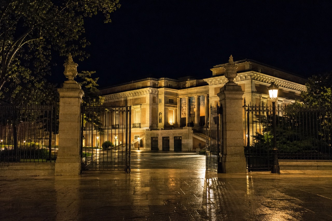 Late afternoon sun on the columned side entrance of a large stone gallery on the Paseo del Prado